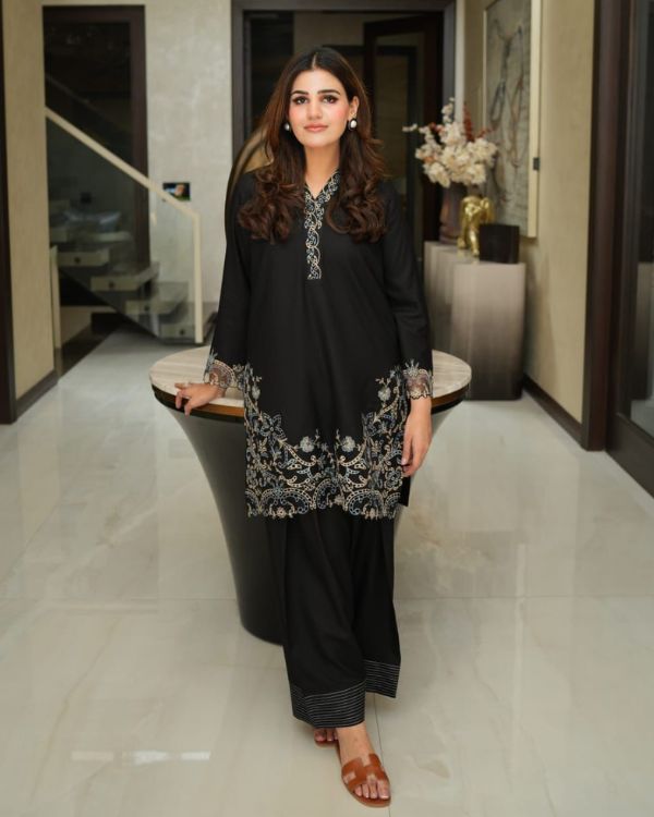 AINOOR This black Marina prêt outfit is a true reflection of timeless elegance, beautifully enhanced with intricate cutwork embroidery on the sleeves, neckline, daman ,back and shalwar bottoms. Every detail is thoughtfully crafted to create a graceful silhouette
