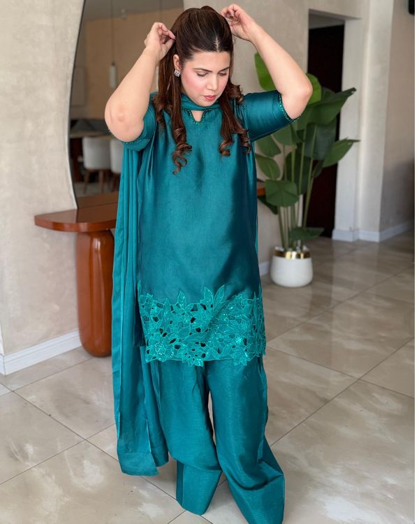 RESHAM This elegant green ensemble showcases a beautifully tailored short shirt paired with a traditional Farshi shalwar, creating a graceful and sophisticated look. Made from smooth medium silk fabric,