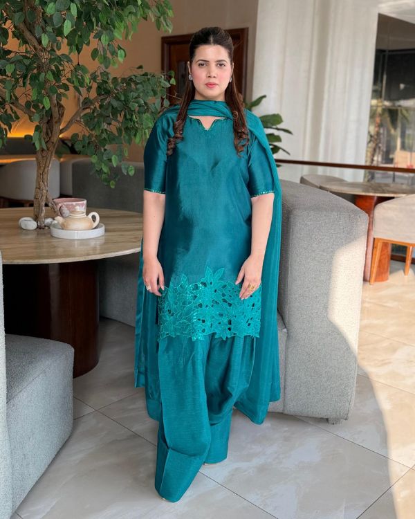 This elegant green ensemble showcases a beautifully tailored short shirt paired with a traditional Farshi shalwar, creating a graceful and sophisticated look. Made from smooth medium silk fabric.
